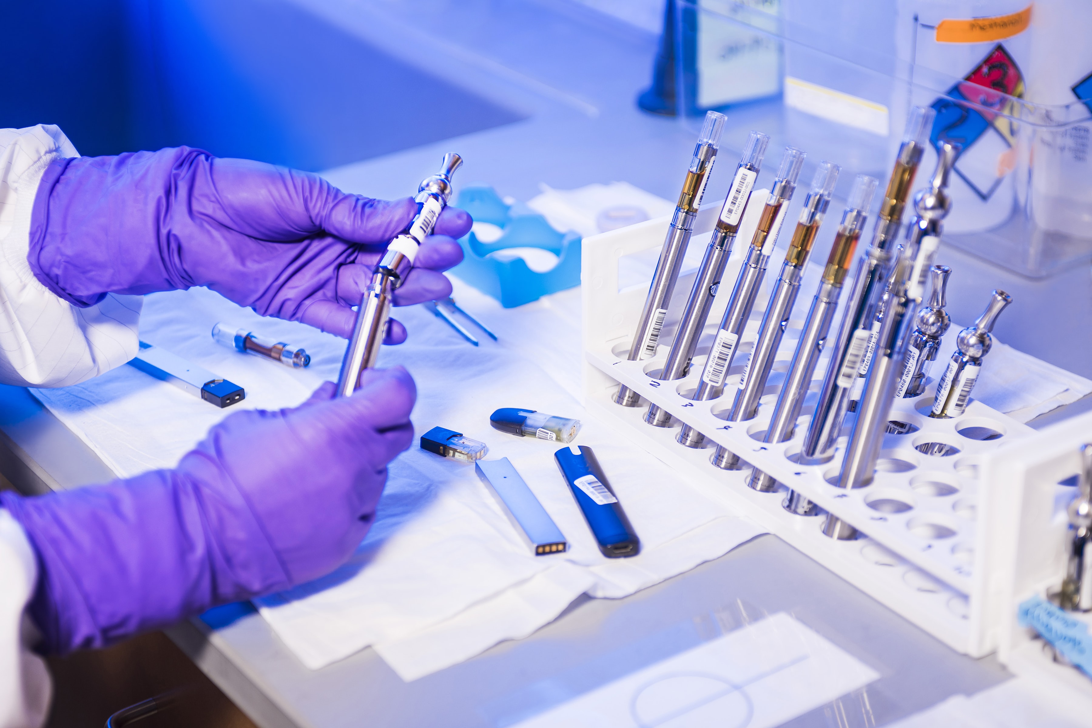 researcher putting together lab equipment with purple gloves