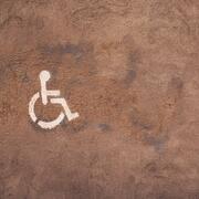 a wheelchair symbol to the left with a light brown background.