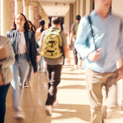 Students walking along a campus pathway, suggesting the transition from college learning to professional practice.