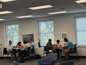 members of faculty sitting at high top tables in UMKC's Faculty Commons