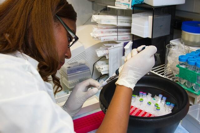 researcher piping specimen into a test tube