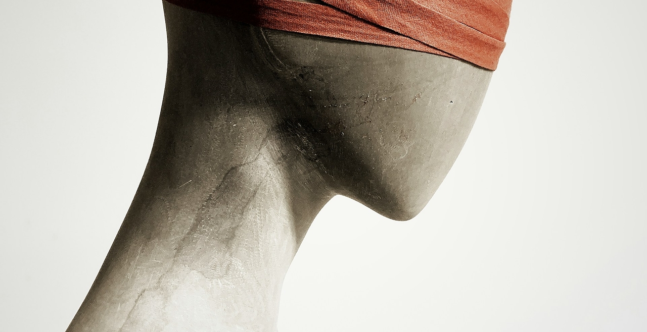 blind-folded gender neutral statue with no facial features, hair or clothes.