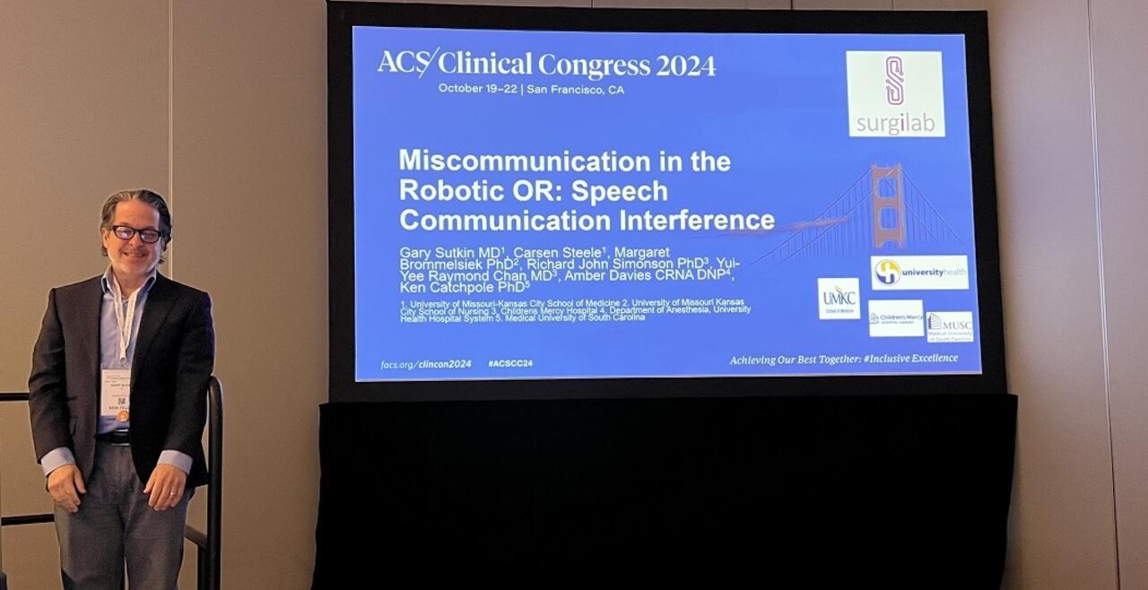 Image of Dr Sutkin next to screen