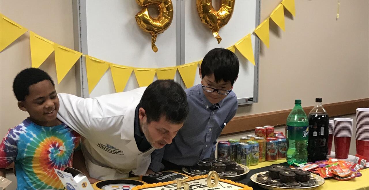 Man blowing out candles on birthday cake