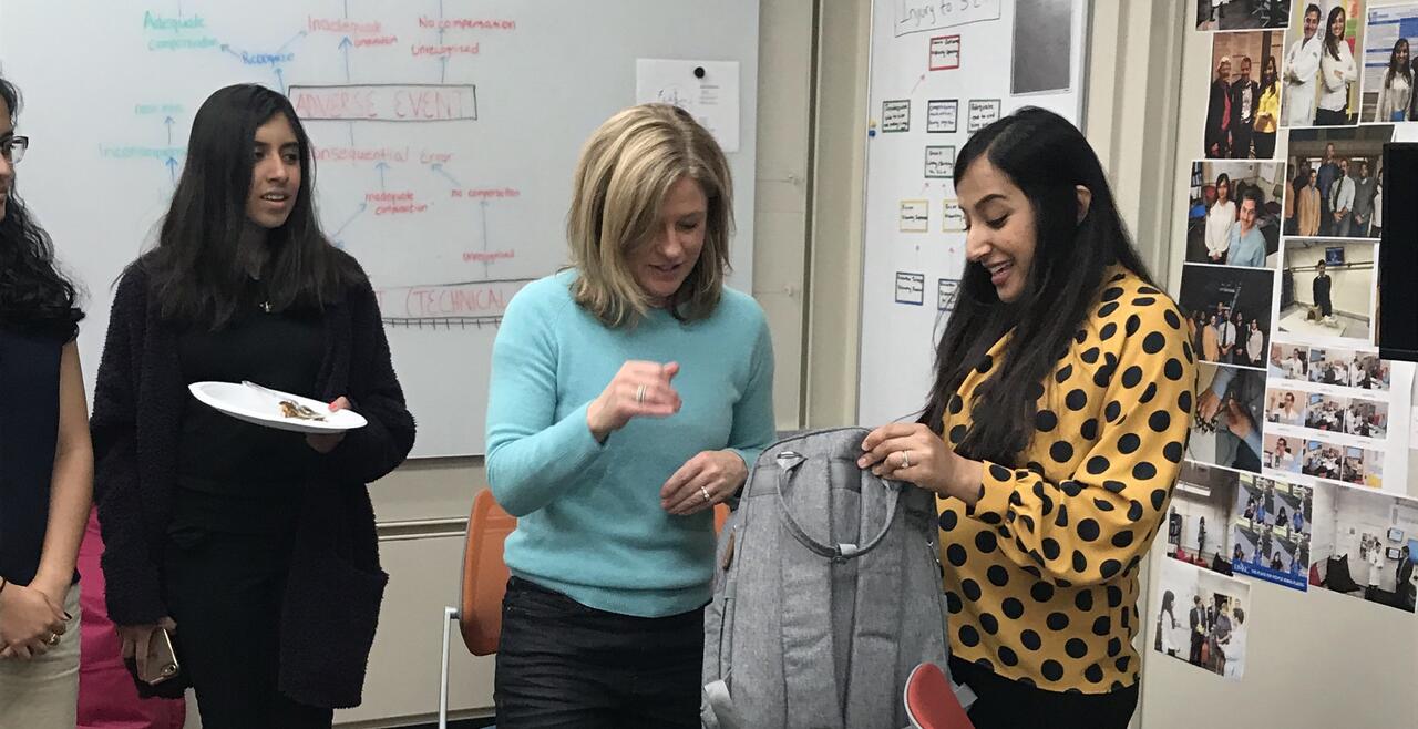 Image of woman opening a gift