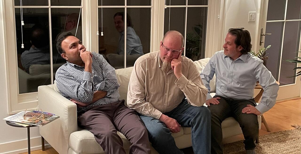 3 men on a couch