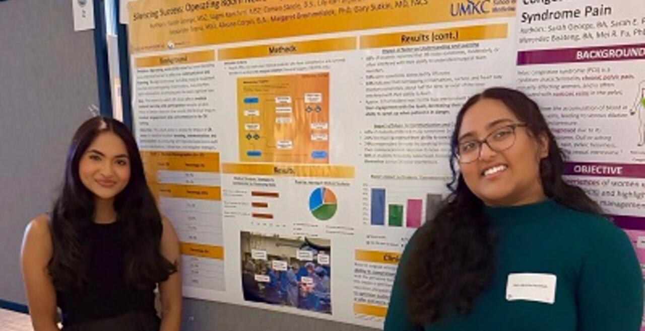 Sarah and Vagmi next to their prize winning poster