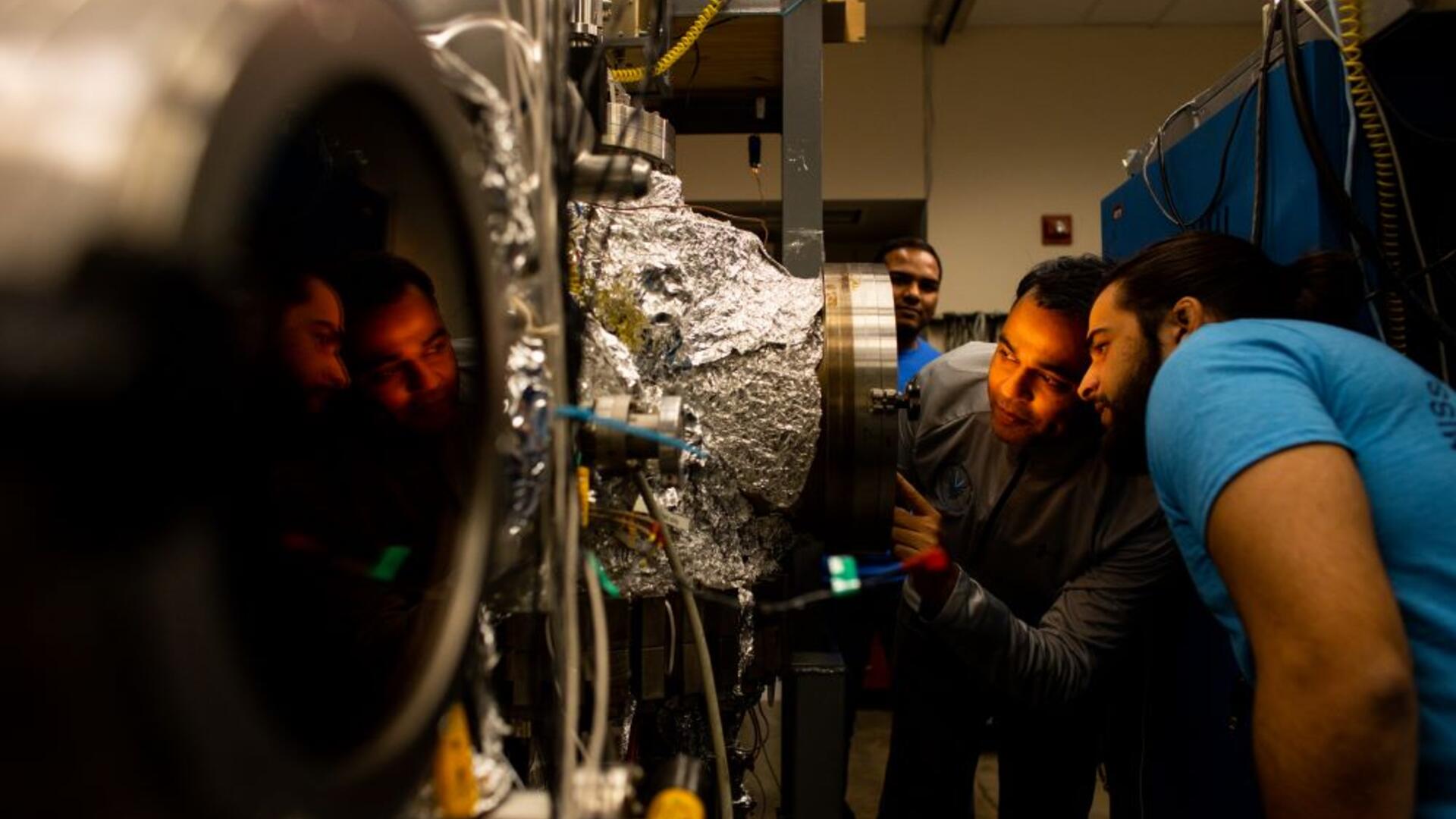 Students looking into PECVD chamber