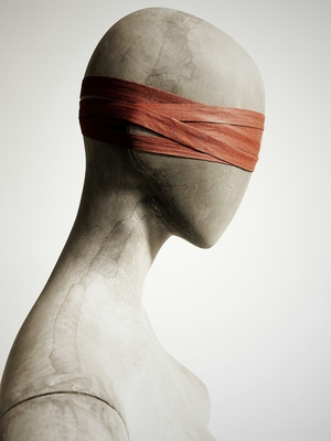 A gender neutral torso with eyes blind-folded