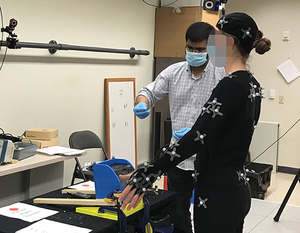Image of a person with motion tracking button on