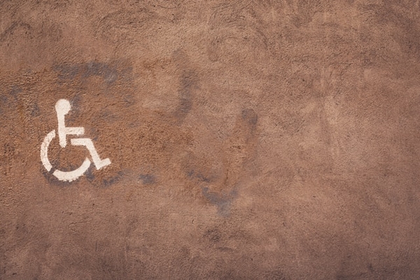 disability icon with a brown back ground