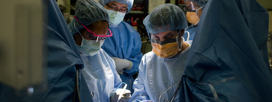 Dr Sutkin and team performing surgery in an operating room